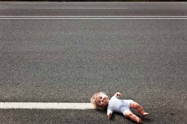 Doll leave on a highway lane clipart