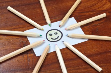 Pencil sun on wooden table clipart