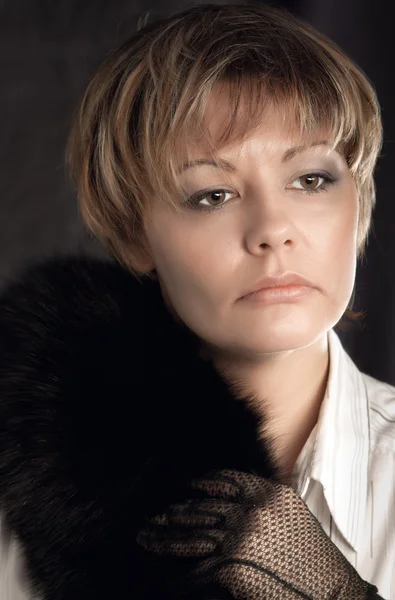 Portrait of beautiful woman wearing gloves and black fur — Stock Photo, Image