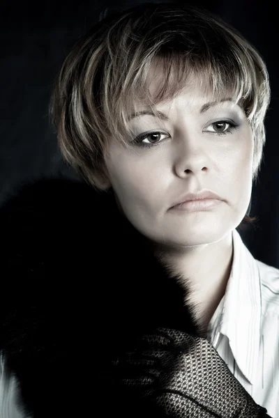 Portrait of beautiful woman wearing gloves and black fur — Stock Photo, Image
