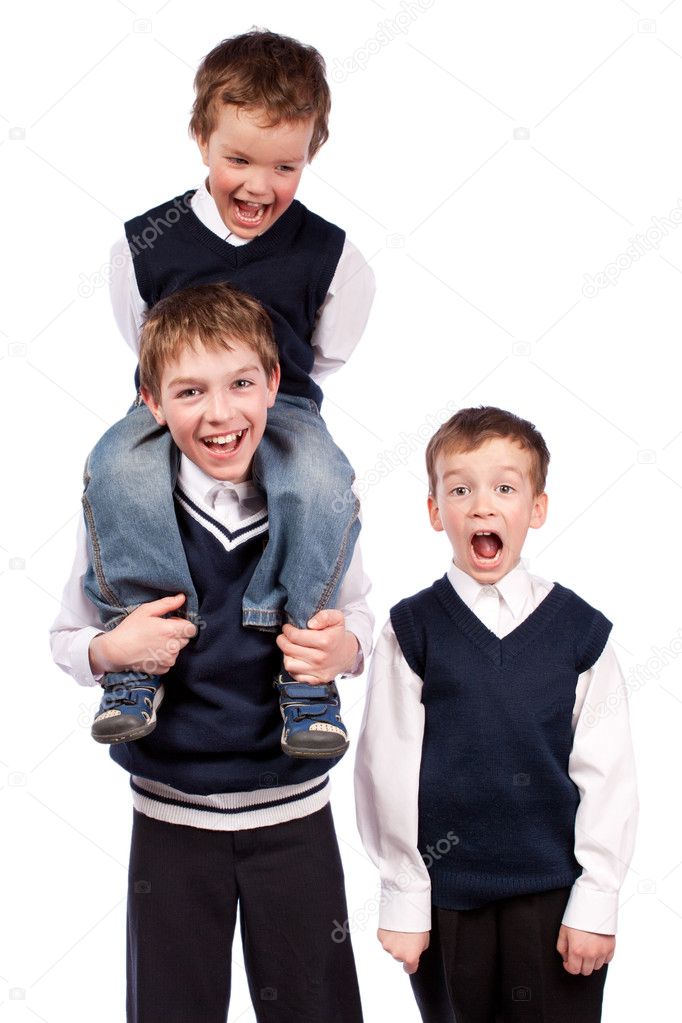 Portrait of three fun brothers in school uniform, isolation