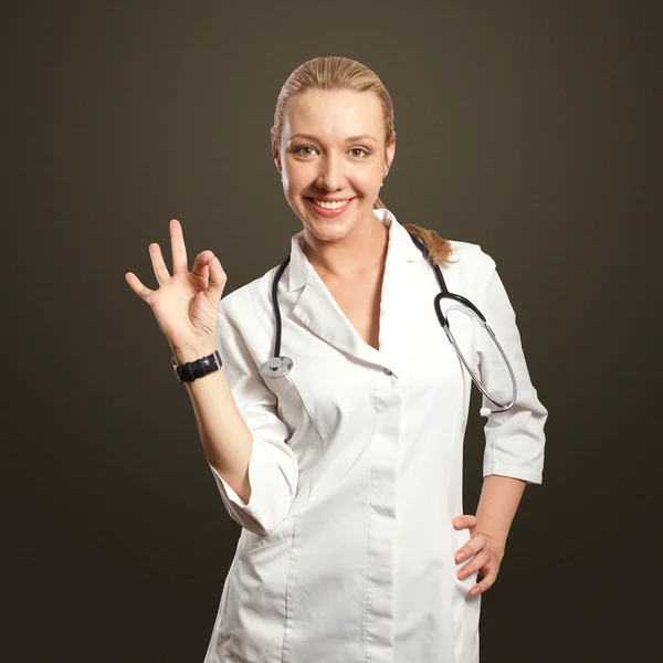 Jovem médico mulher mostra ok — Fotografia de Stock