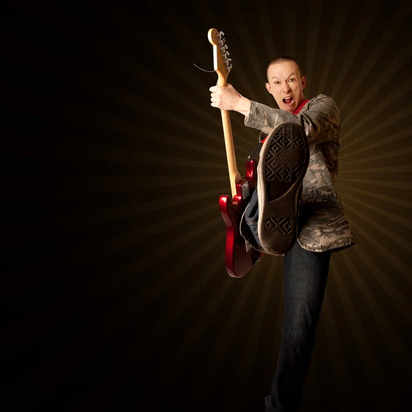 Rocker with guitar and foot — Stock Photo, Image