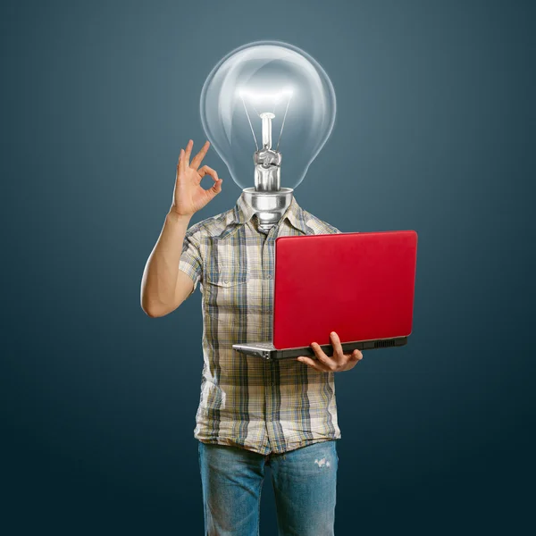 Casual lamp-head with laptop shows OK — Stockfoto