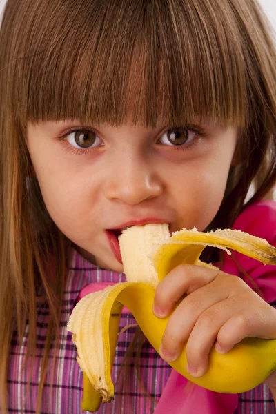 Little girl eating banana — Stock Photo, Image