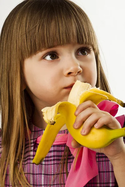 Menina bonita feliz com banana no fundo branco — Fotografia de Stock
