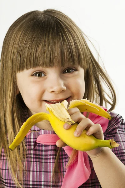 Menina bonita feliz com banana no fundo branco — Fotografia de Stock