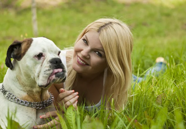 Girl with a dog on the grass — Stock Photo, Image
