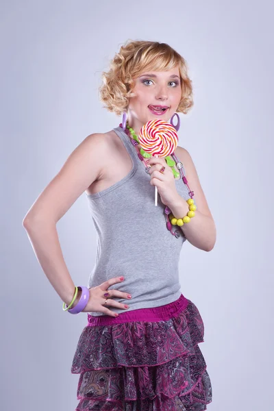 Pretty young woman with lollipop candy — Zdjęcie stockowe