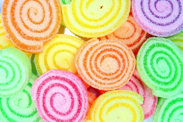 Kleurrijke suikergoed op een achtergrond. — Stockfoto