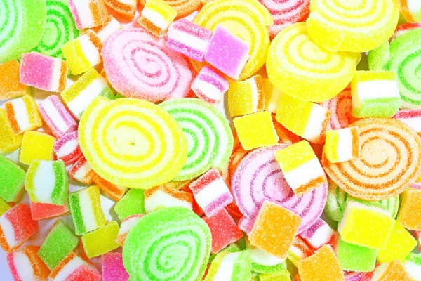 Barevné sladkosti na pozadí. — Stock fotografie