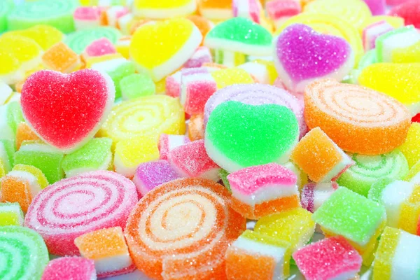 Kolorowe cukierki na tle. — Zdjęcie stockowe