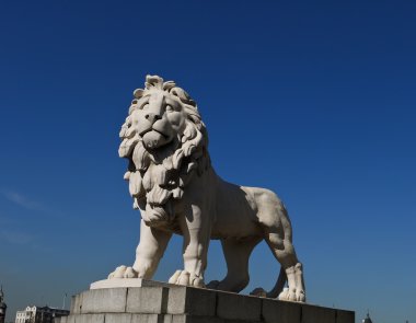 White lion statue guarding in London clipart