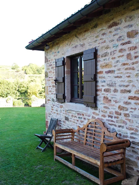 Деревянная скамейка и стул в доме в саду — стоковое фото