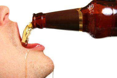 Beer is being poured into the mouth from bottle clipart