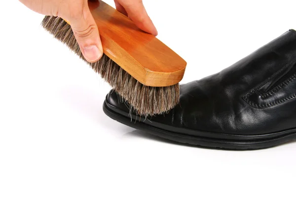 Hand with brush cleaning shoe — Stock Photo, Image