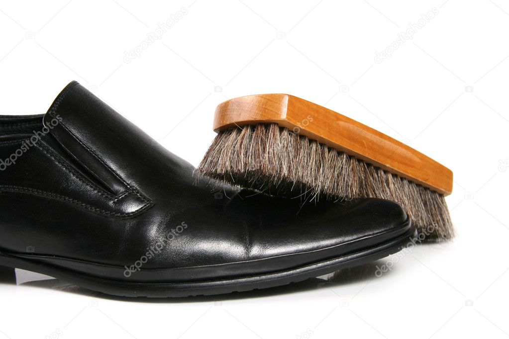 Black leather shoe and brush