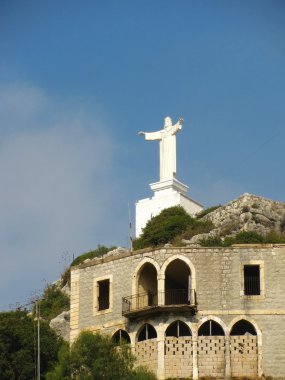 Statue over a building in Beirut clipart