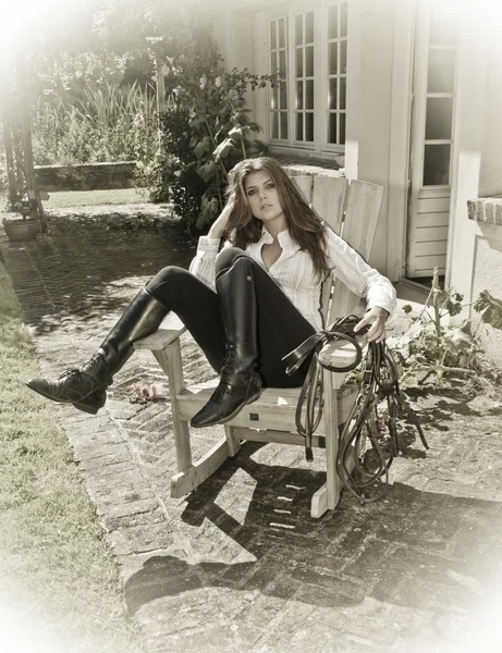Horse woman in an outdoor chair sensual with boots and white shi — Stock Photo, Image