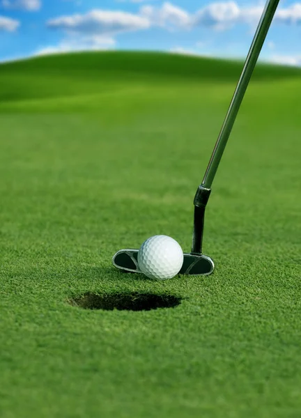 Golfclub en bal in gras Stockfoto