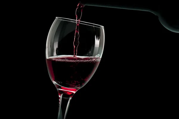 Glass of red wine with bottle — Stock Photo, Image