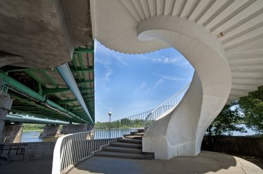 Modern spiral stairway on the bridge clipart