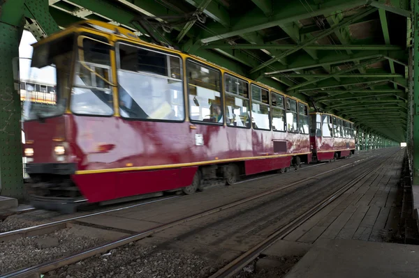 Red tram in Warsaw on old bridge — Stock Photo, Image