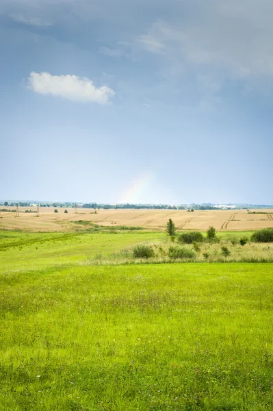 Countryside landscape with rainbow — Stock Photo, Image