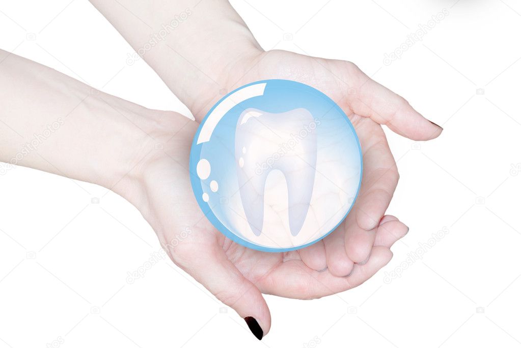 Hands holding tooth in glass sphere, dentistry