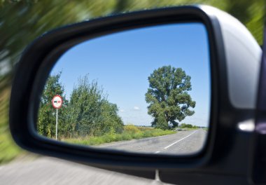 Road in the car mirror clipart