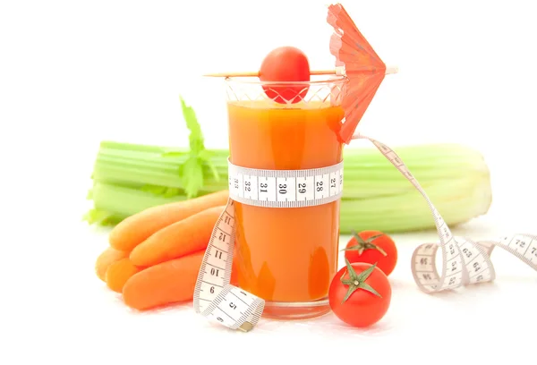 Glass of vegetable juice with tape measure — Stock Photo, Image