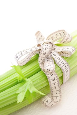 Celery with tape measure, concept of diet clipart