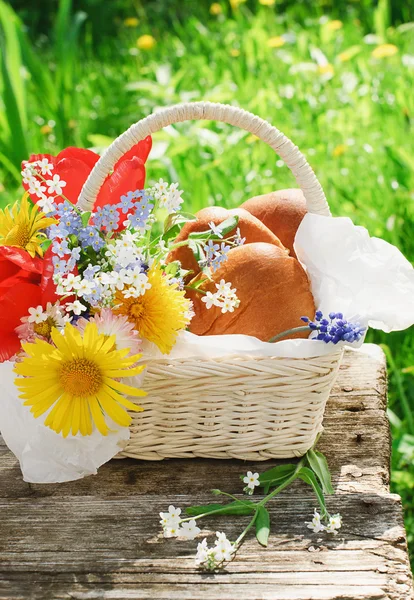 Un cesto con polpette e fiori in giardino — Foto Stock