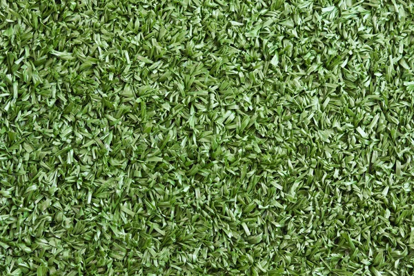 Textura de fondo con hierba falsa en un parque infantil público — Foto de Stock