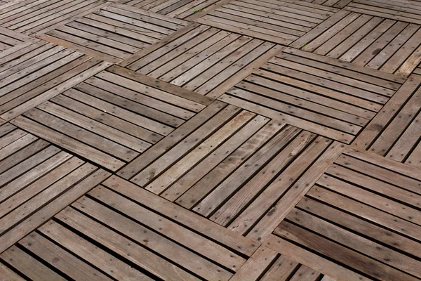 Patterns and textures of a wooden planks pavement — Stock Photo, Image