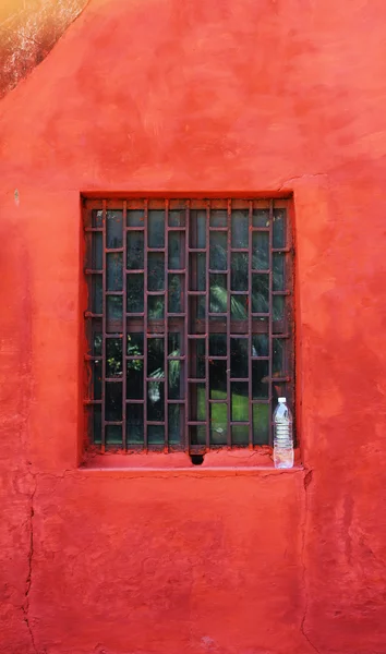 Jantar mantar červenou zeď s lahví — Stock fotografie