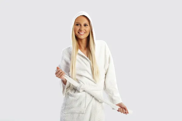 Pretty girl in a white bathrobe, smiling — Stock Photo, Image