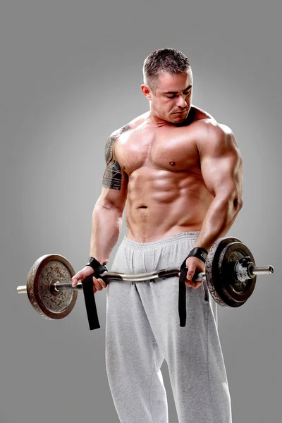 Bodybuilder lifting weights — Stock Photo, Image