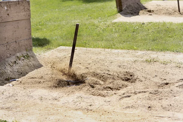 stock image Flying sand as the Horseshoe ringer is made.