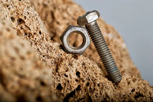 Bolt pushing a nut Royalty Free Stock Images