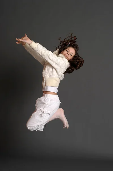 Menina de vestido branco saltando em estúdio — Fotografia de Stock