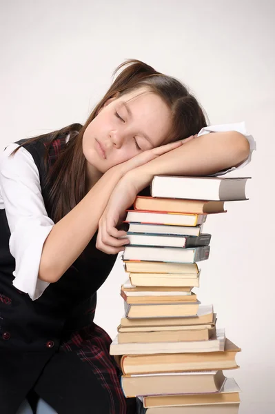 Girl with a big stack of books — Stockfoto
