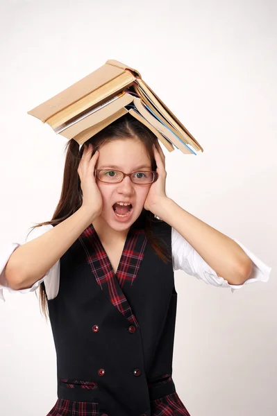 Menina com uma grande pilha de livros — Fotografia de Stock