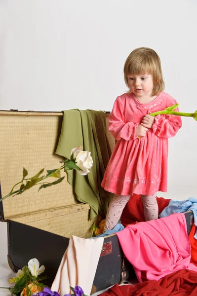 Little girl and an old suitcase — Stock Photo, Image