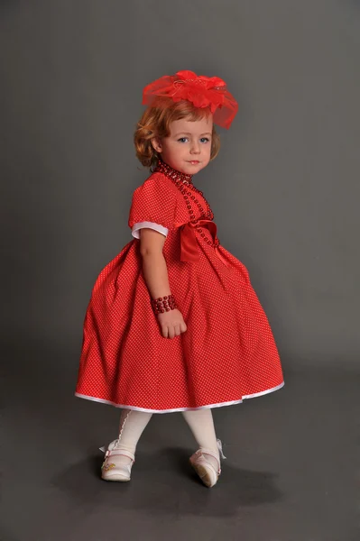 Маленька дівчинка, одягнена в червону сукню — стокове фото