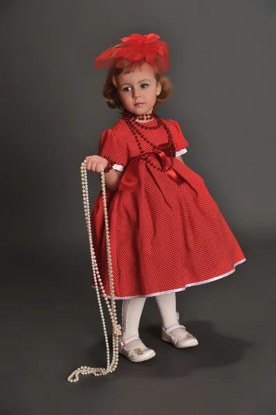 A little girl dressed in a red dress — Φωτογραφία Αρχείου