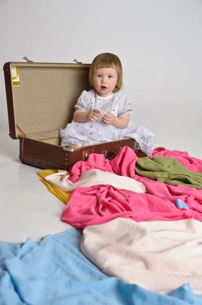 Little girl and an old suitcase — Stock Photo, Image