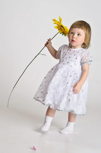 Little girl with a sunflower — Stock Photo, Image