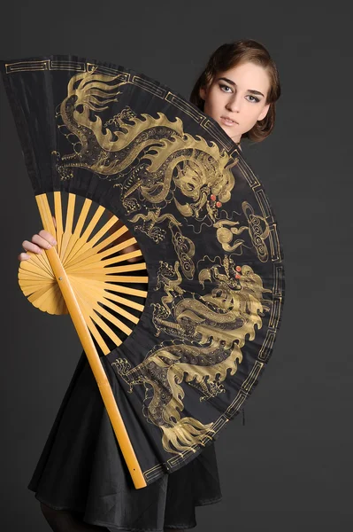 Woman with large fan — Stock Photo, Image