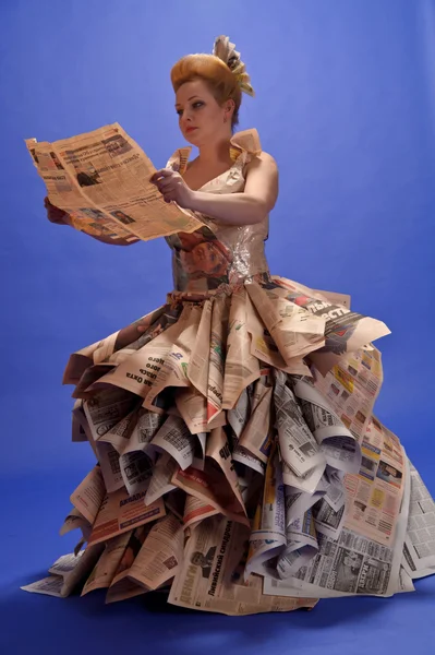 Girl in newspapers — Stock Photo, Image